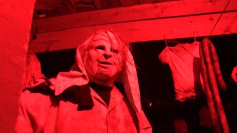 A volunteer is ready to scare the daylights out of visitors.