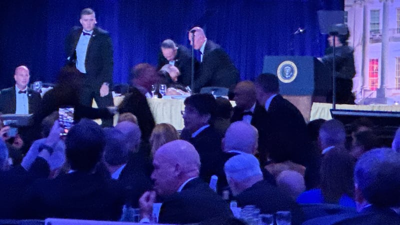 Secret service agents respond during the White House Correspondents Dinner, Saturday, April...